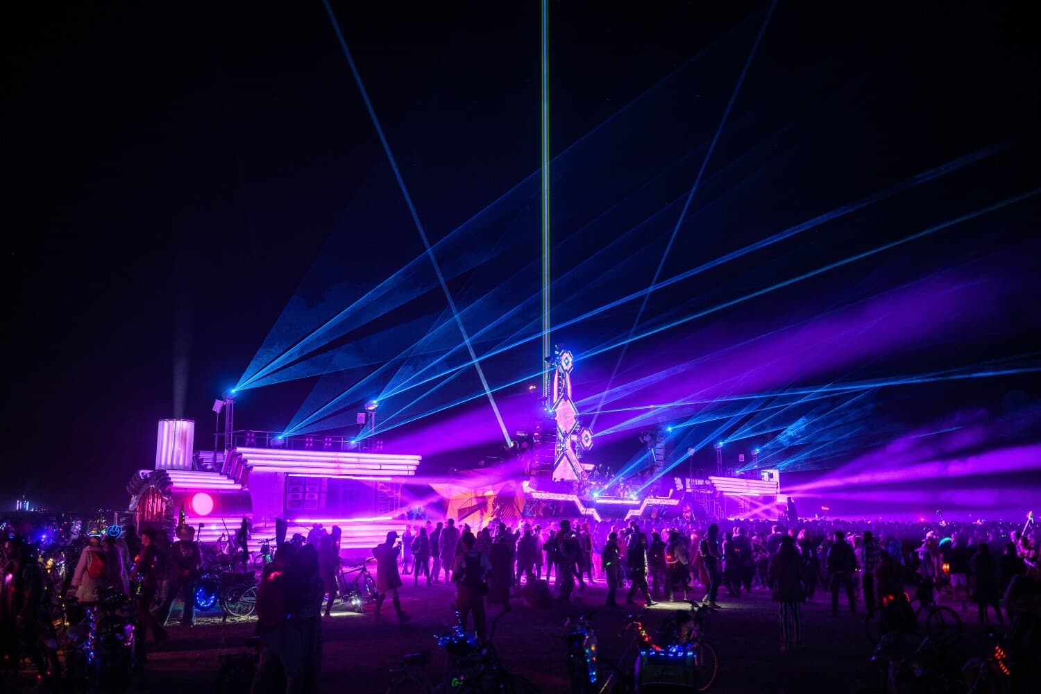 BiPolar Express and Mayan Warrior linked under violet light and blue lasers