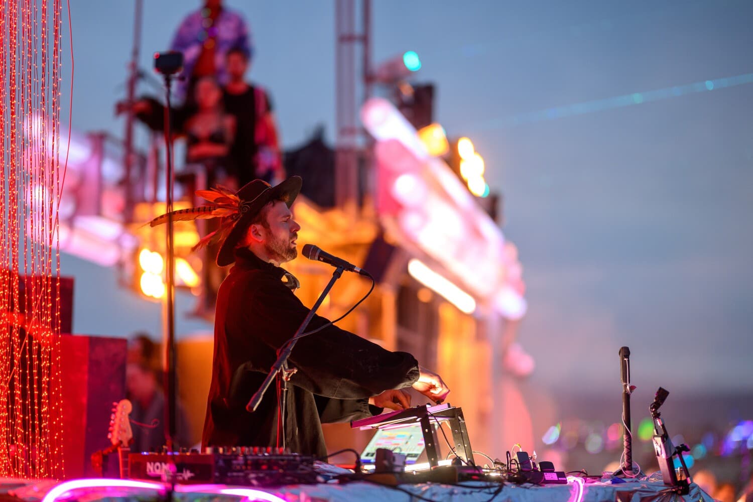 Monolink performing live beside Singularity Tree, with BiPolar Express behind him