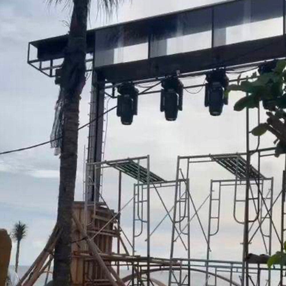 Lighting rig being staged on the venue's superstructure.