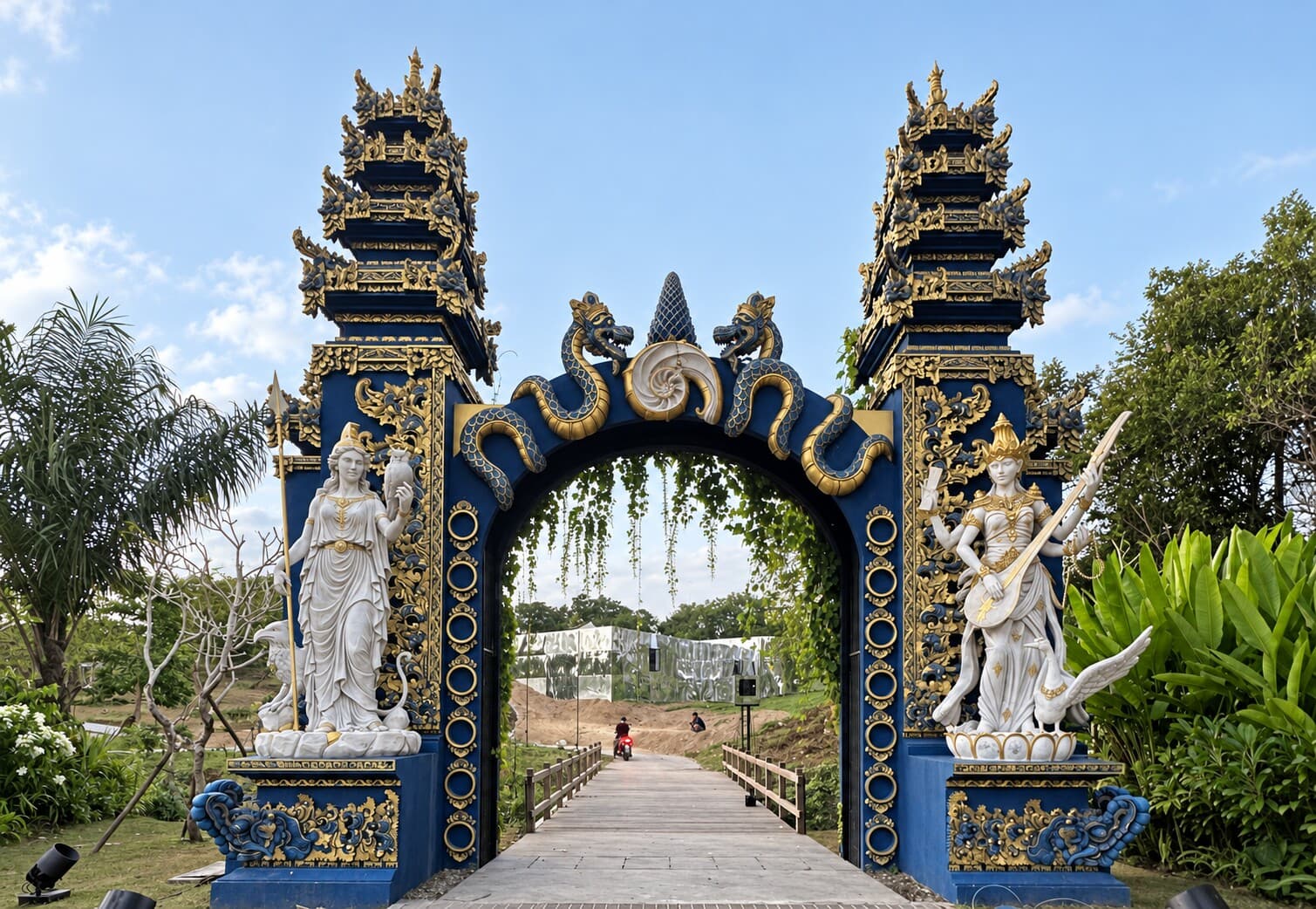 Completed Nuanu Gate in daylight, framing the pedestrian bridge into Nuanu Creative City