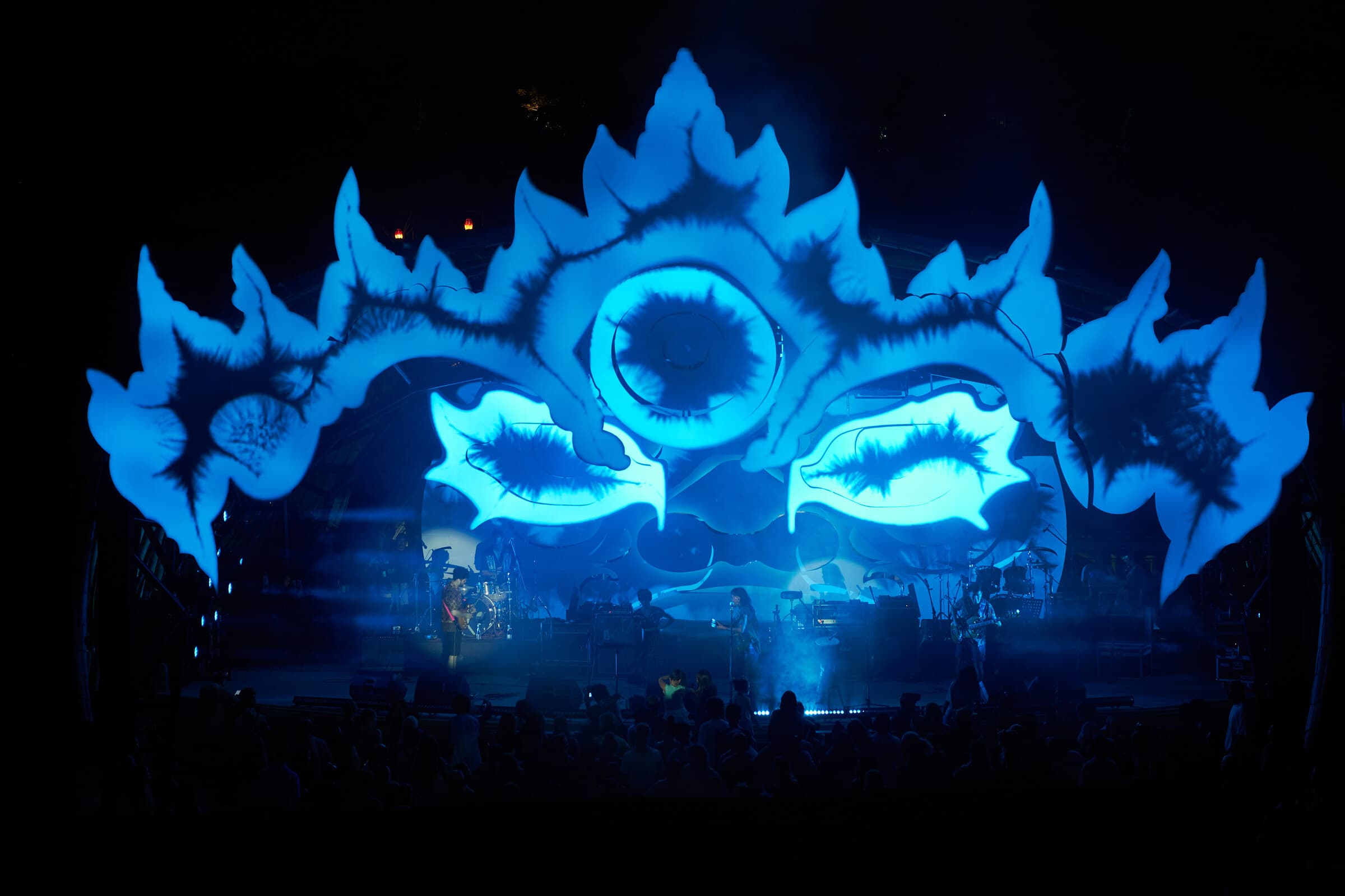 The Barong-inspired Suara stage illuminated in blue with musicians performing below